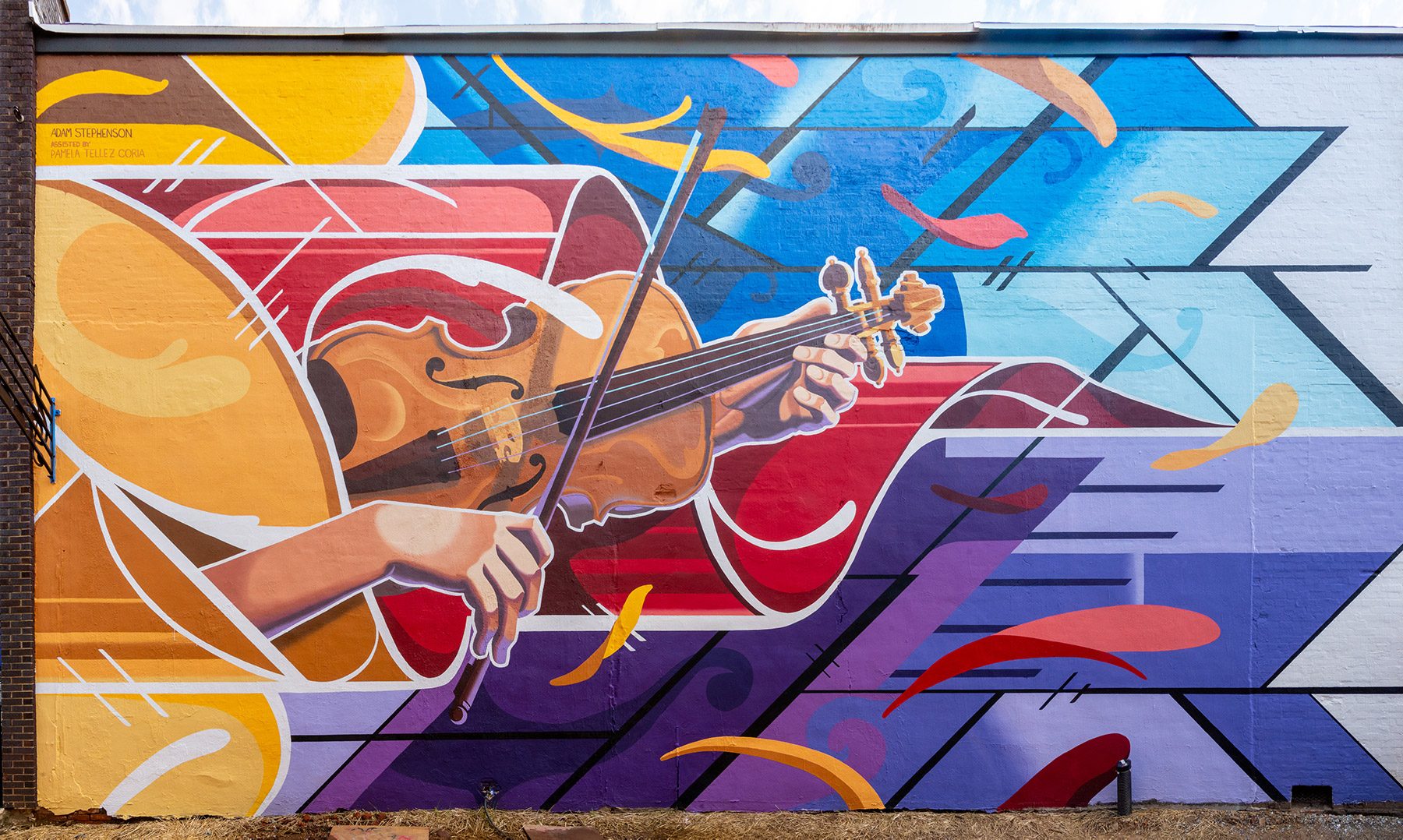 Playing the Sound of the Wind — 24×48 ft mural by Adam Stephenson honoring the Tennessee Valley Old Time Fiddlers Convention in downtown Athens, Alabama (2021)