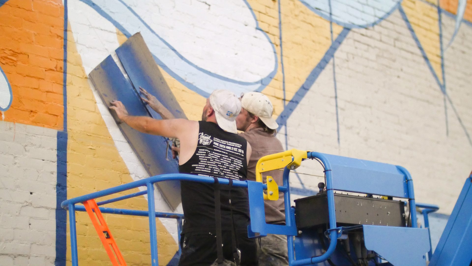 Homecoming mural close-up of hand and flower detail by Adam Stephenson, Decatur, Alabama