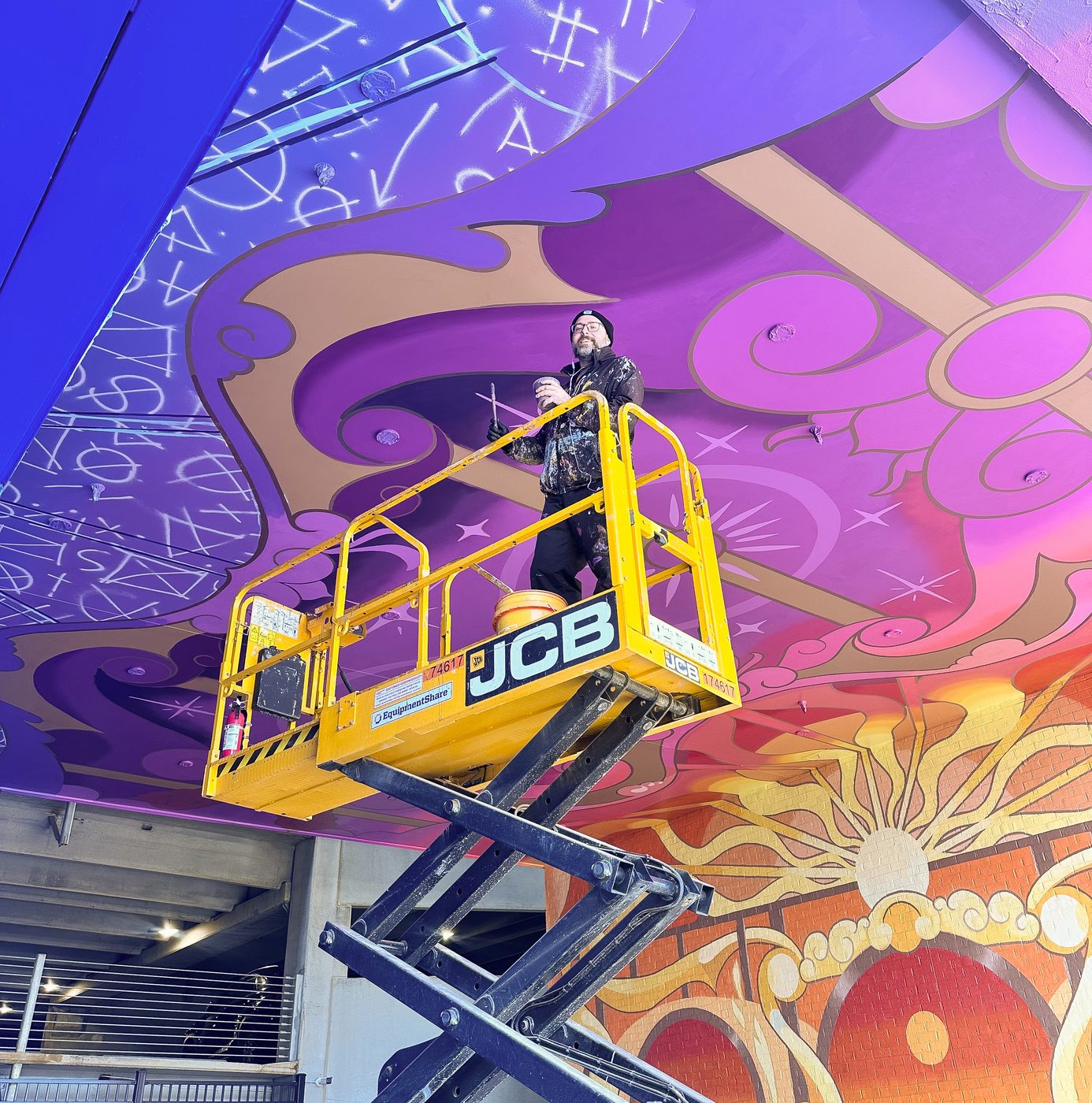Adam Stephenson painting The Upton mural in progress, Atlanta GA