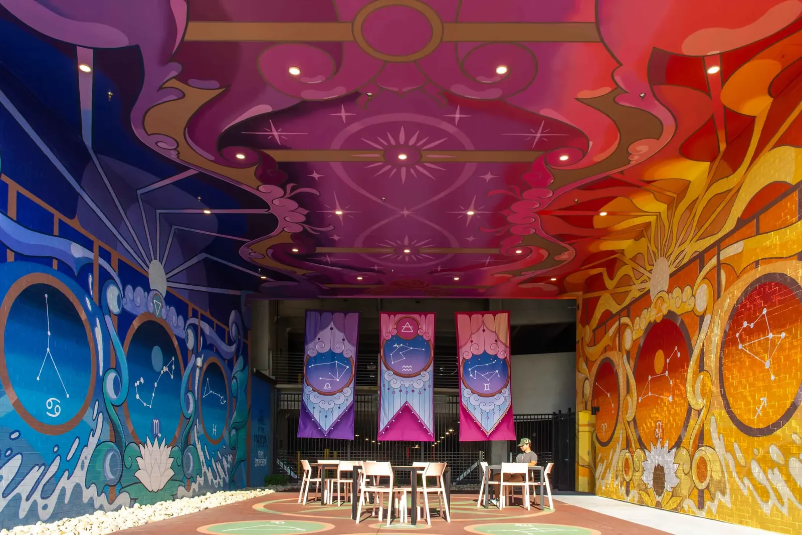 Inside The Hall of the Magician: painted ceiling, water and fire walls, hanging banners and constellation floor