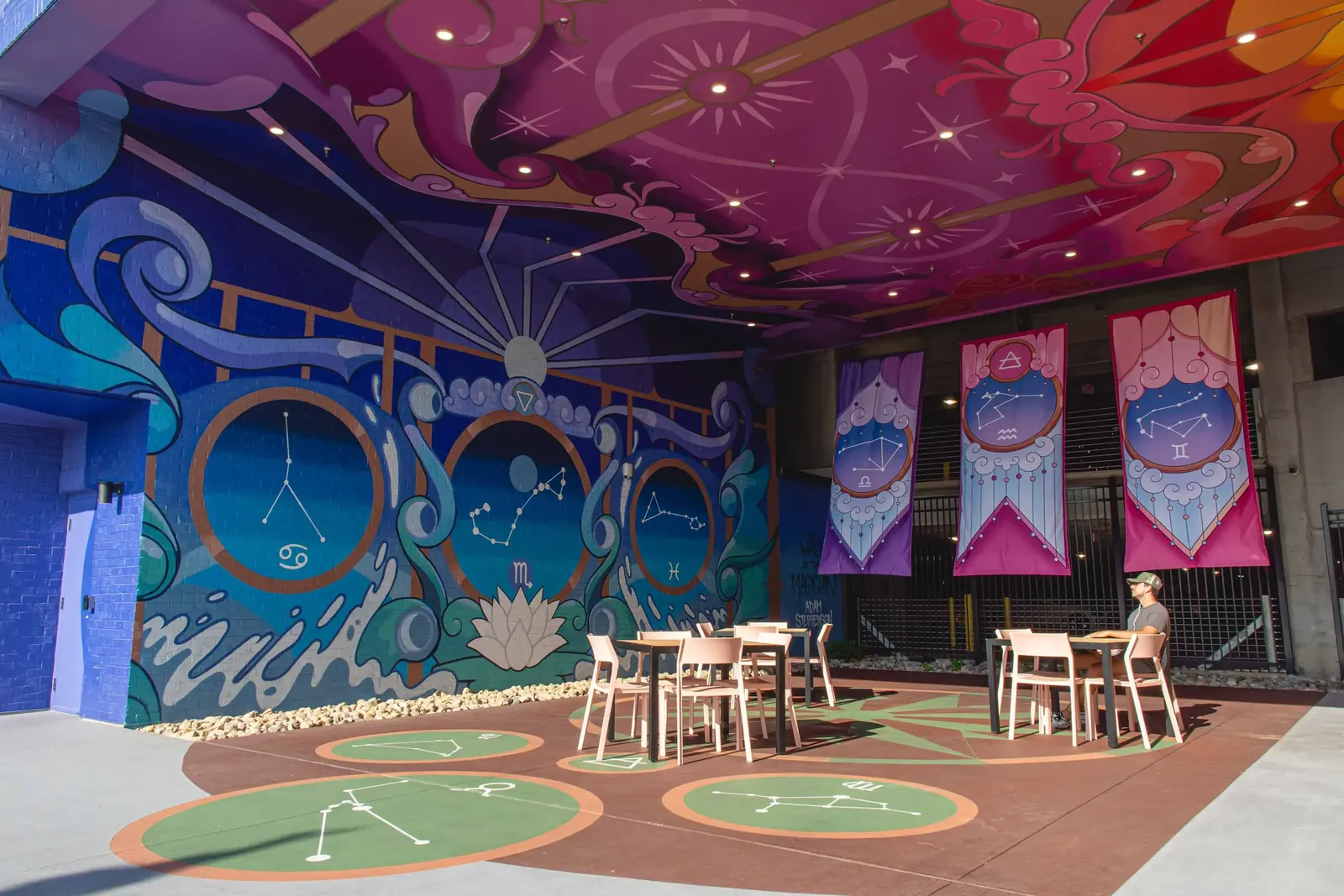 The water wall of The Hall of the Magician: a moonrise, a water lily and three circular frames holding the Cancer, Scorpio and Pisces constellations